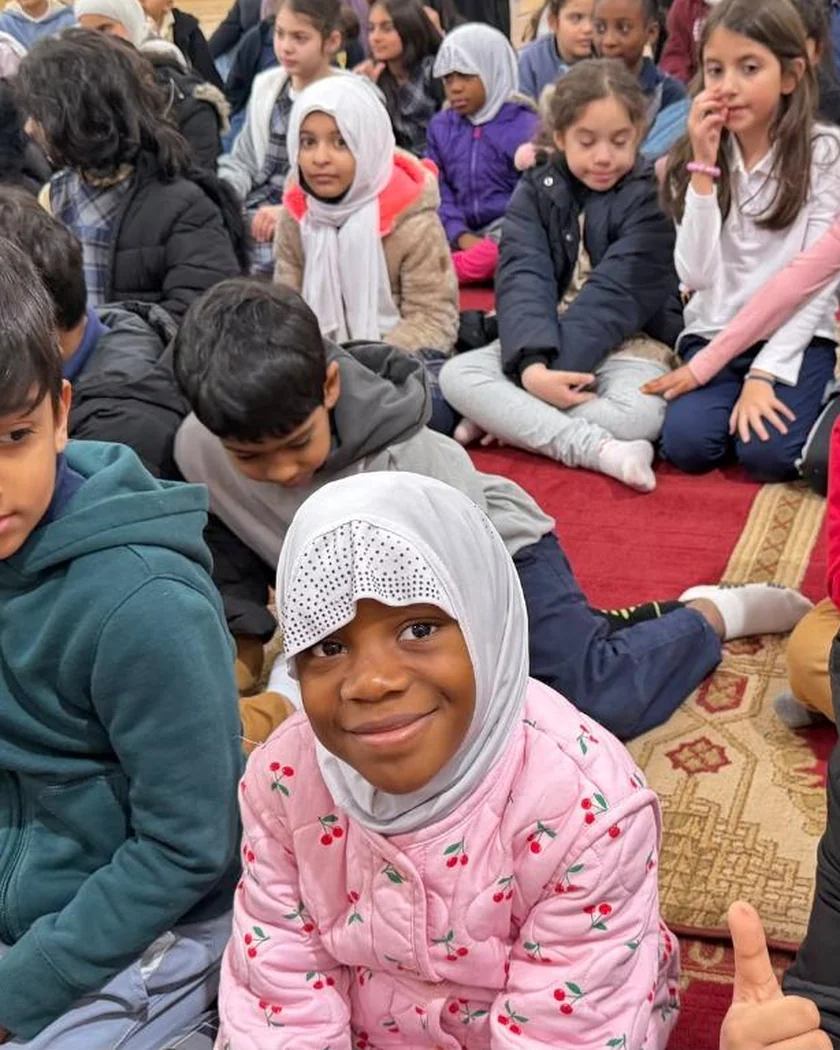 Students sitting together on the prayer carpet