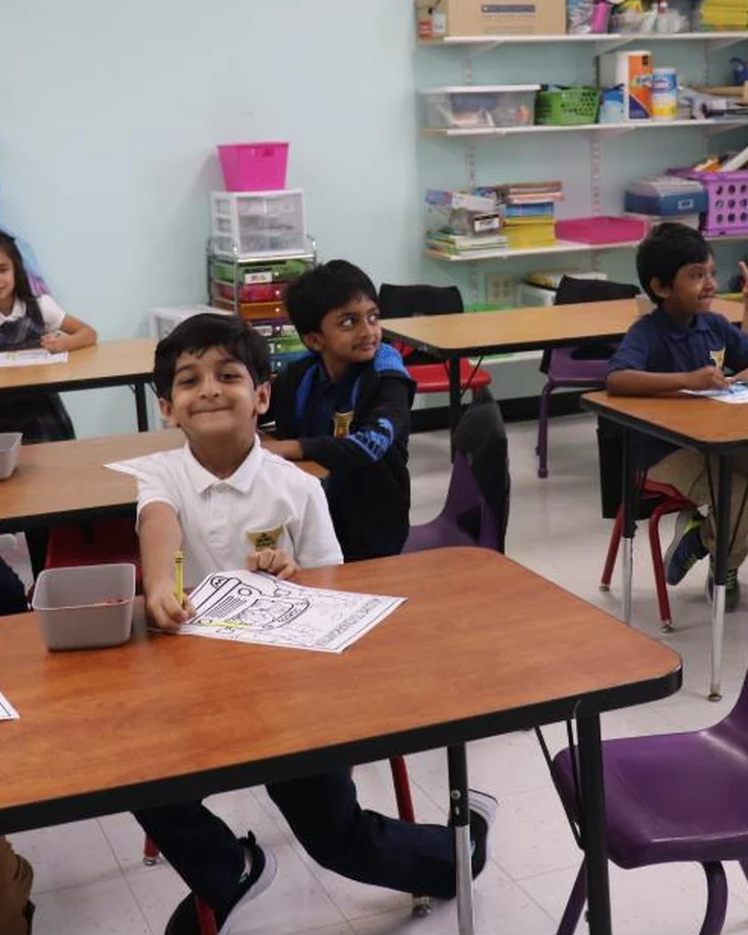 Young children at their classroom tables on the first day